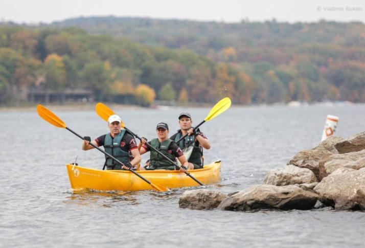 A group of males kayaking