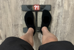 Man weighing himself on scale